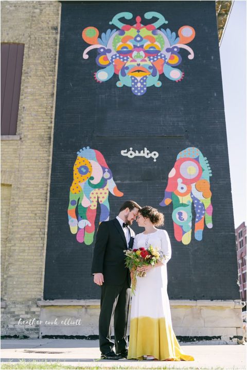 modern milwaukee wedding in fall: yellow dip dyed wedding dress in front of street art mural