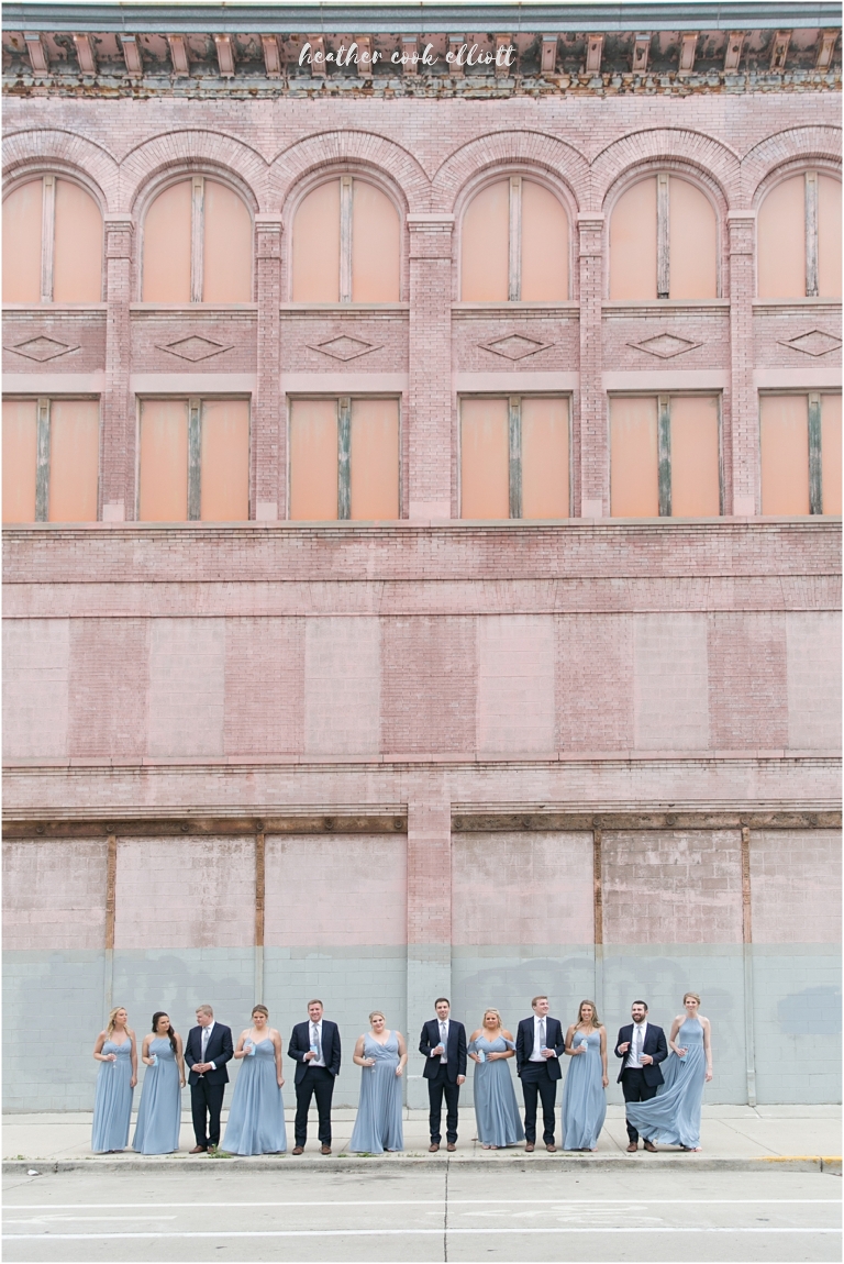 awesome bridal party portrait with pink wall at pritzlaff